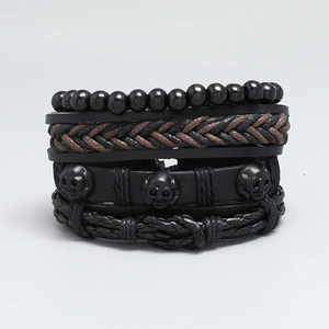 Set of four men's vintage black woven leather bracelets featuring skull charms and beads