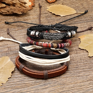 Vintage bohemian multilayer leather bracelet set with woven cords and a silver feather charm