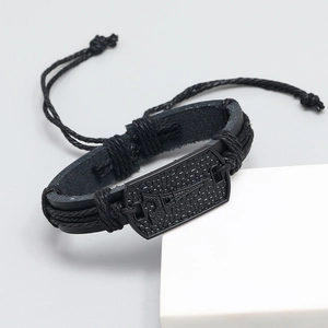 Minimalist black braided leather bracelet featuring an Eiffel Tower metal plate detail