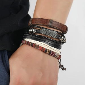 Handmade vintage leather bracelet set for men featuring a feather charm and tribal beads