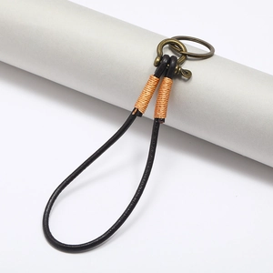Retro black leather car keychain with orange thread detail and brass horseshoe buckle