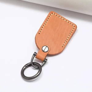 Handmade vintage leather car keychain with rustic stitching and gun-grey metal ring