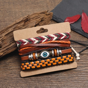 Bohemian multilayer leather bracelet set with blue evil eye pendant on wooden background