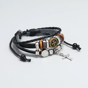 Detail of vintage multilayer braided leather bracelet with cross pendant and beads