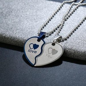 Macro detail of splittable heart pendant necklace with Love You engraving and bead chains