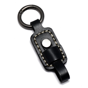 Handmade black leather keychain with gun-gray spring clip and vintage white stitching