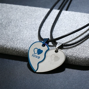 Detail of split heart couple necklace with engraved love you message on woven cords