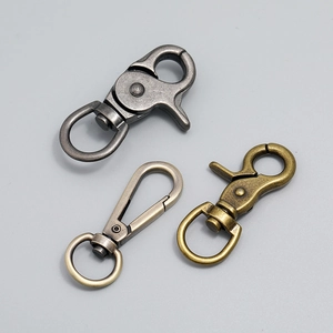 Macro detail of swivel lobster clasps in gun black, bronze, and brushed nickel finish