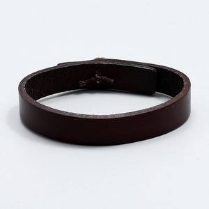 Detailed macro view of retro dark brown leather bracelet with wide single-band texture