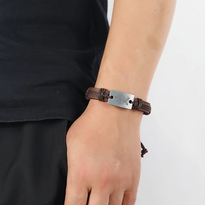 Men's vintage brown woven leather bracelet with a matte rectangular metal plate