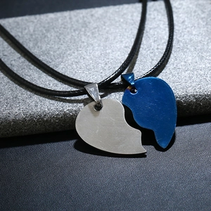 Detail of split heart couple necklaces in silver and blue brushed steel finish
