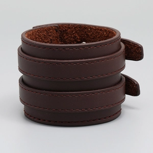 Detail view of deep brown multi-layer leather cuff with dark stitched edges for men