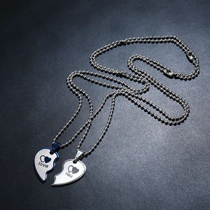 Detail of blue and silver stainless steel heart puzzle necklace with Love You engraving