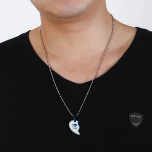Detail of silver bead chain and half-heart pendant with love engraving for men