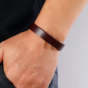 Close-up of deep brown leather bracelet showing premium texture on wrist