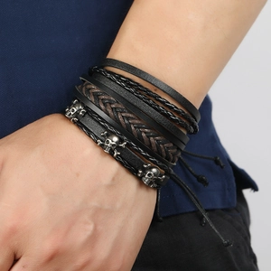 Vintage multi-layer braided leather bracelet set for men featuring skull charms