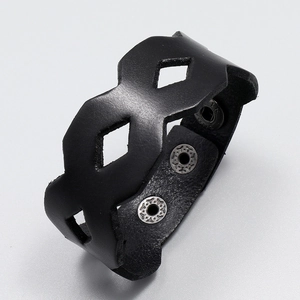 Detail of wide black leather hollowed cuff bracelet with three silver metal snap buttons