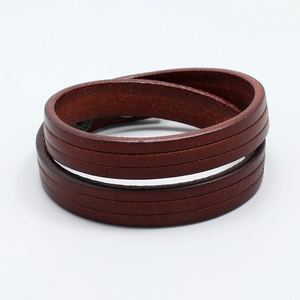 Detail of dark brown double-wrap leather bracelet with parallel decorative indentations