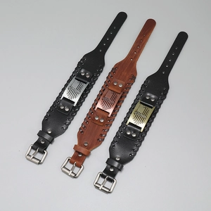 Detail of punk leather wristbands featuring US flag plaque and braided stitch edges
