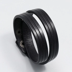 Detail of black double-wrap leather bracelet with vintage metal snap button closure