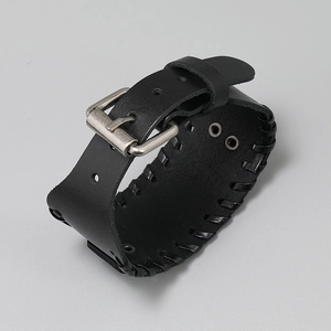 Close-up of vintage punk braided leather bracelet with silver buckle and eyelets