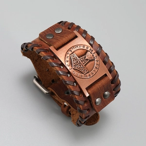 Macro view of Viking Mjolnir leather bracelet with embossed runes and bronze details