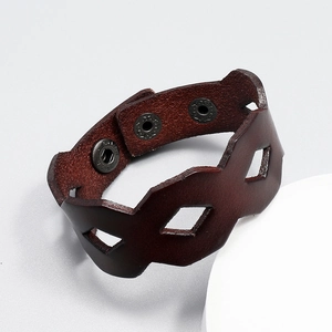 Detail of red-brown hollow out leather bracelet with adjustable triple metal buttons