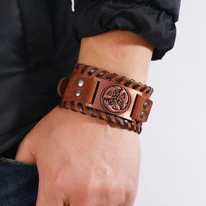 Retro wide brown woven leather bracelet for men featuring a bronze Celtic knot metal badge