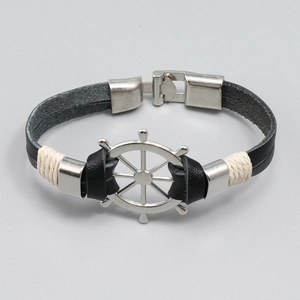Handmade nautical black leather bracelet featuring a silver ship wheel and metal clasp