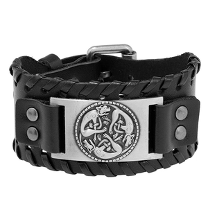 Retro black leather bracelet with braided edges and Celtic knot metal plate on white background