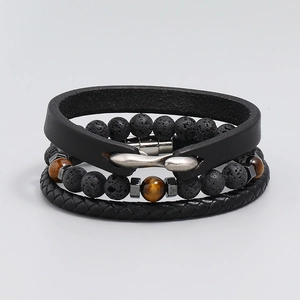 Detail view of men's bracelet set with black leather, lava stone and tiger eye beads