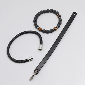 Close-up of men's black leather braid bracelet set with lava rock and tiger eye beads