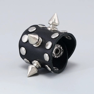 Detailed view of punk style black leather ring with silver metal spikes and rivets