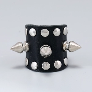 Close-up of punk black leather ring with silver cone studs and metallic rivets detail