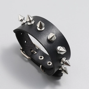 Detail showing the adjustable silver buckle and metal eyelets on the black punk leather strap