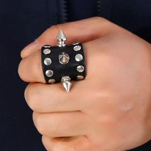Punk style wide black leather ring with silver metal studs and long sharp spikes
