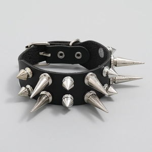 Close-up of punk leather bracelet featuring three rows of silver metal cone spikes