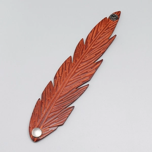 Retro brown leather cuff bracelet featuring a detailed embossed feather pattern design