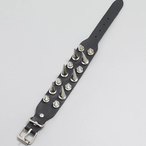 Punk style leather bracelet with two rows of silver metal spikes and buckle closure