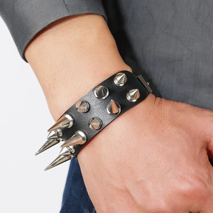 Punk rocker leather bracelet with two rows of silver metal spikes on a male wrist