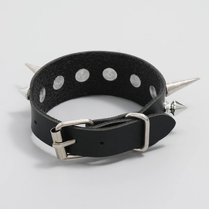 Close-up of black punk leather bracelet with silver spikes and adjustable buckle detail