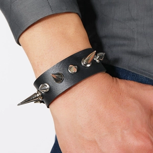 Punk style black leather bracelet featuring bold silver metal cone spikes and rivets