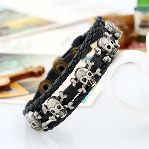 Black multilayer braided leather bracelet featuring vintage silver skull and crossbones