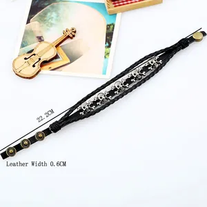 Black multilayer braided leather skull bracelet for men featuring silver metal charms