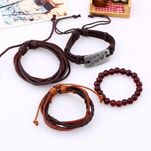 Detail of four-piece set brown leather and beaded bracelets with silver Love engraving