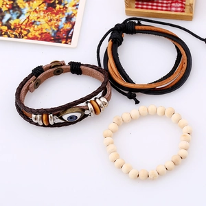 Detail view of multi-layer leather bracelets with evil eye charm and wooden beads