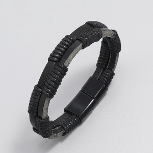 Detail of hand-woven black leather bracelet with magnetic metal clasp for men