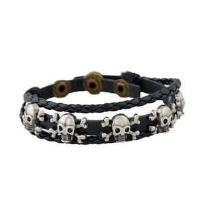 Multilayer braided leather bracelet with vintage silver skull charms and punk style
