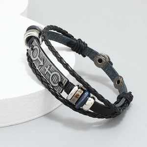 Macro detail of punk black leather braided bracelet with interlocking gender symbols