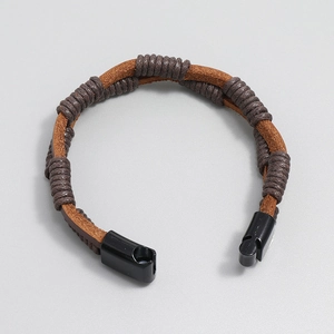 Detail of hand-woven brown leather bracelet with dark wax rope and black magnetic clasp
